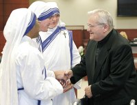 Fr. Donald  McGuire with Missionary of Charity nuns.