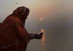 Pilgrim offering a lamp to Ganga Devi at the Kumbha Mela 2013