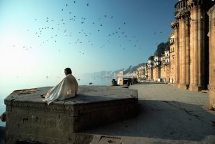 Devotee watching the sun rise on the ghat at Varanasi