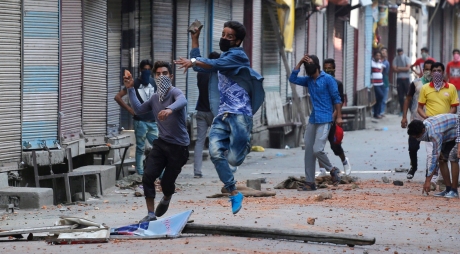 Kashmiri Muslim protesters throw stones at Indian policemen during clashes in Srinagar, the summer capital of Indian Kashmir, 11 July 2016. Clashes between civilians and police in India's northern region of Kashmir has spiked to at least 16 in the third day of violent unrest that has engulfed the Valley since the funeral of famed separatist militant Burhan Muzaffar Wani on 09 July. A curfew remains in place in many parts of the city, forbidding people from leaving their houses at any point during the day. EPA/FAROOQ KHAN
