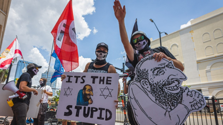 Demonstrators hold anti-Semitic signs as they protest in Tampa, Florida (July 23, 2022).